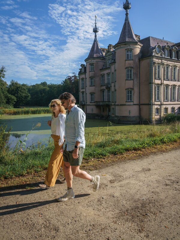 Koppel wandelt voorbij het Kasteel van Poeke